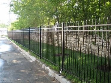 Black sliding gate adding style to a suburban home