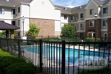 Residential house with a black aluminum sliding gate for added privacy.