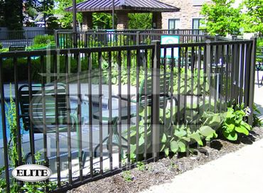 Black aluminum sliding gate providing security for a contemporary house.