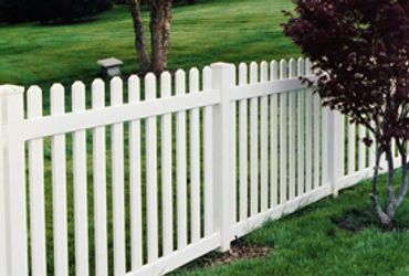 White wooden gate in front of a suburban residential home