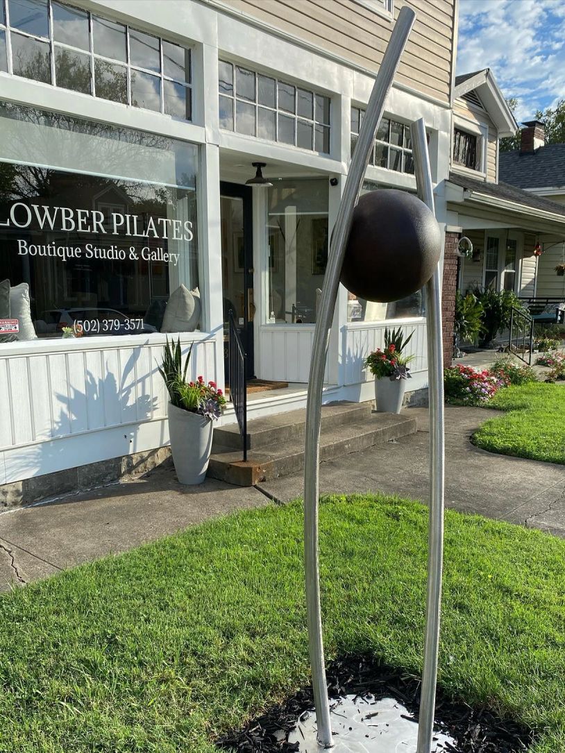 Modern metal sculpture outside Pilates studio.