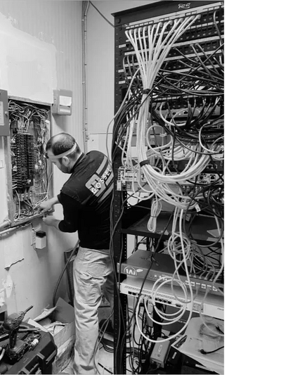 Licensed industrial electrician upgrading a high-voltage panel in a manufacturing facility in NH.