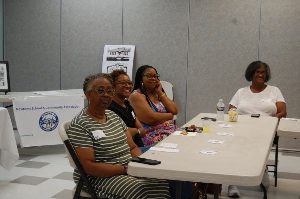 Community members sitting together at a table.