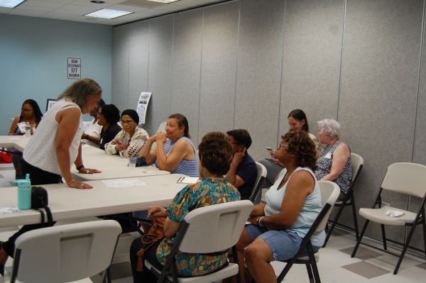 Group of women having a discussion at a table.