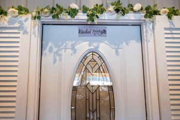 White door with glass panel and floral decoration above it.