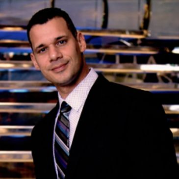 Man in a suit smiling.