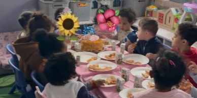 Children having a party with pizza and juice.