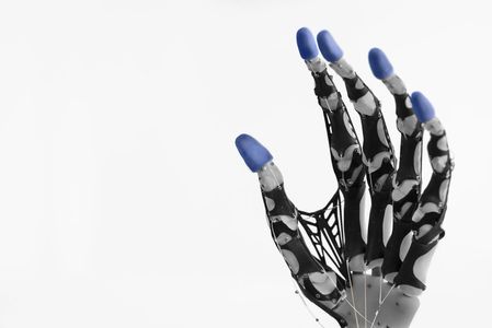 Mechanical robotic hand with blue fingertips on a white background.