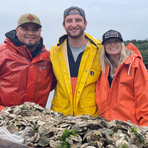 Guests on a North East Salt Water boat touring the oyster farm in Phippsburg, Maine.