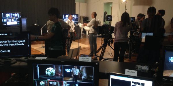 People working in a video production control room.