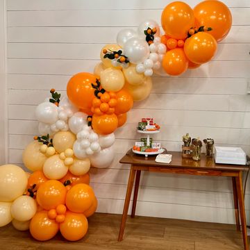 Organic balloon garland with layered sizes and optional custom accents—perfect for walls, tables, or