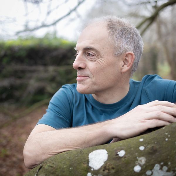 Me (Leo) leaning on a branch, looking out into the woods.