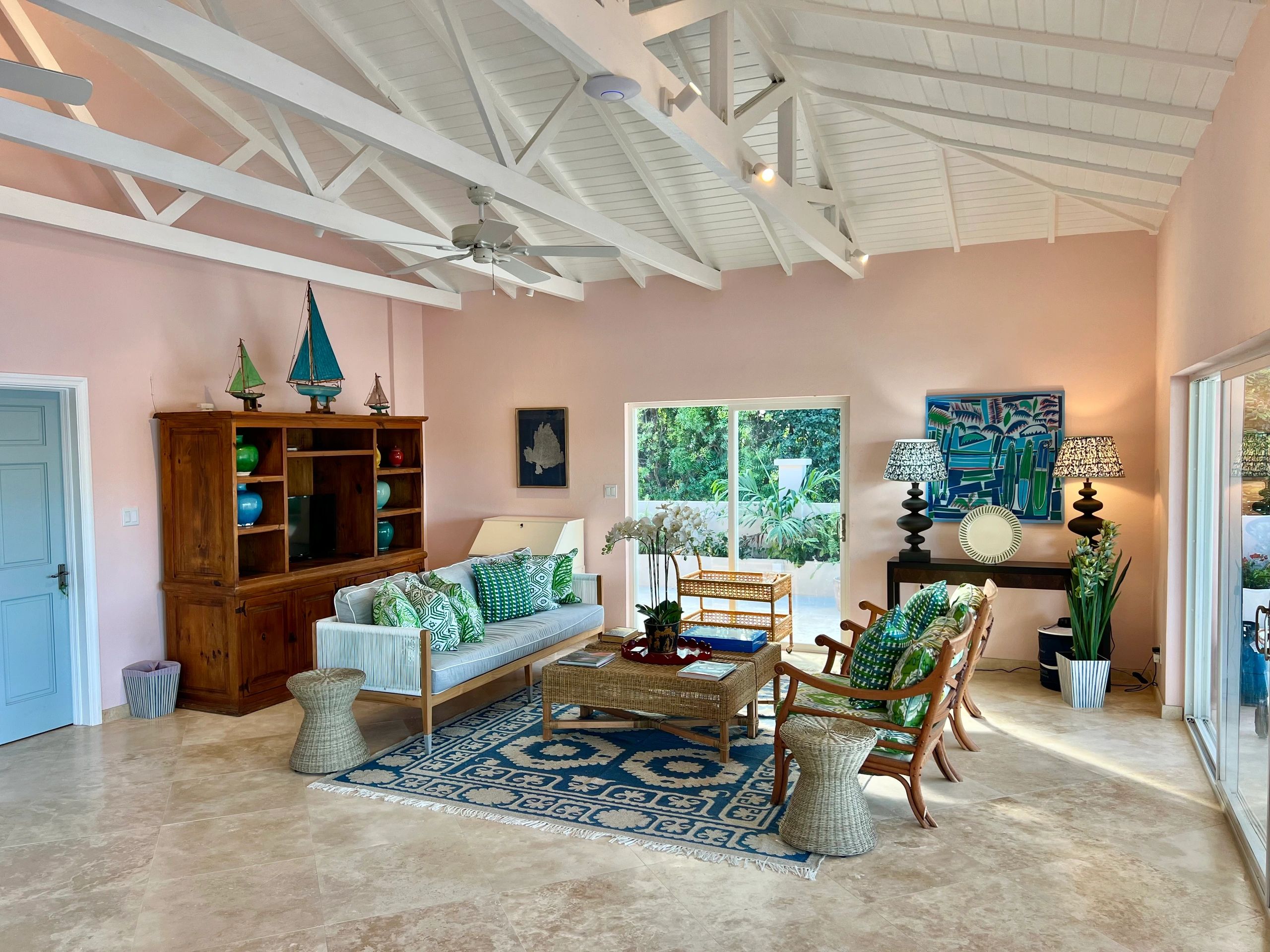 The Pink House living room with framed Hermes scarf, Oka furnishings and antique sailing yachts