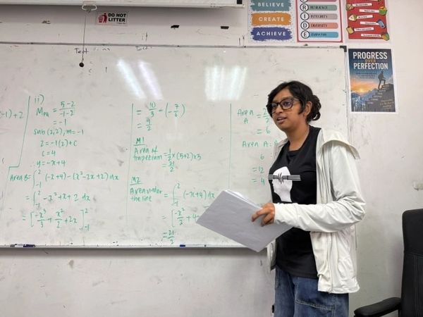 Afreen teaching her fellow classmates how to solve the complex Maths problem with ease.