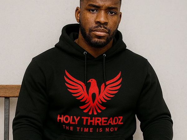 Man wearing a black hoodie and pants with a red phoenix and text design.