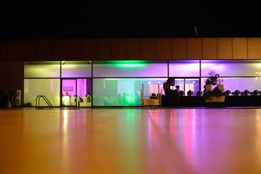 Uplights displayed with muliti-colors in an event space.