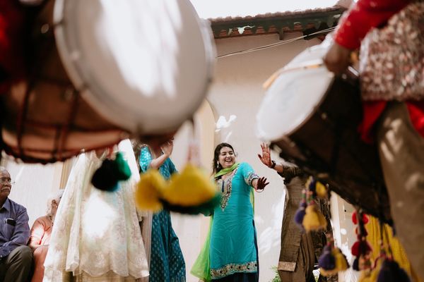 Dholi performing at an outdoor Indian celebration.
