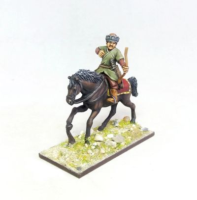 Miniature figure of a mounted archer in traditional attire.