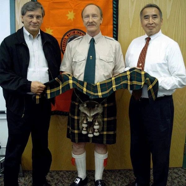 Picture of chief with two men receive a gift 
