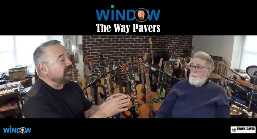 Two men in a music-filled room during an interview.