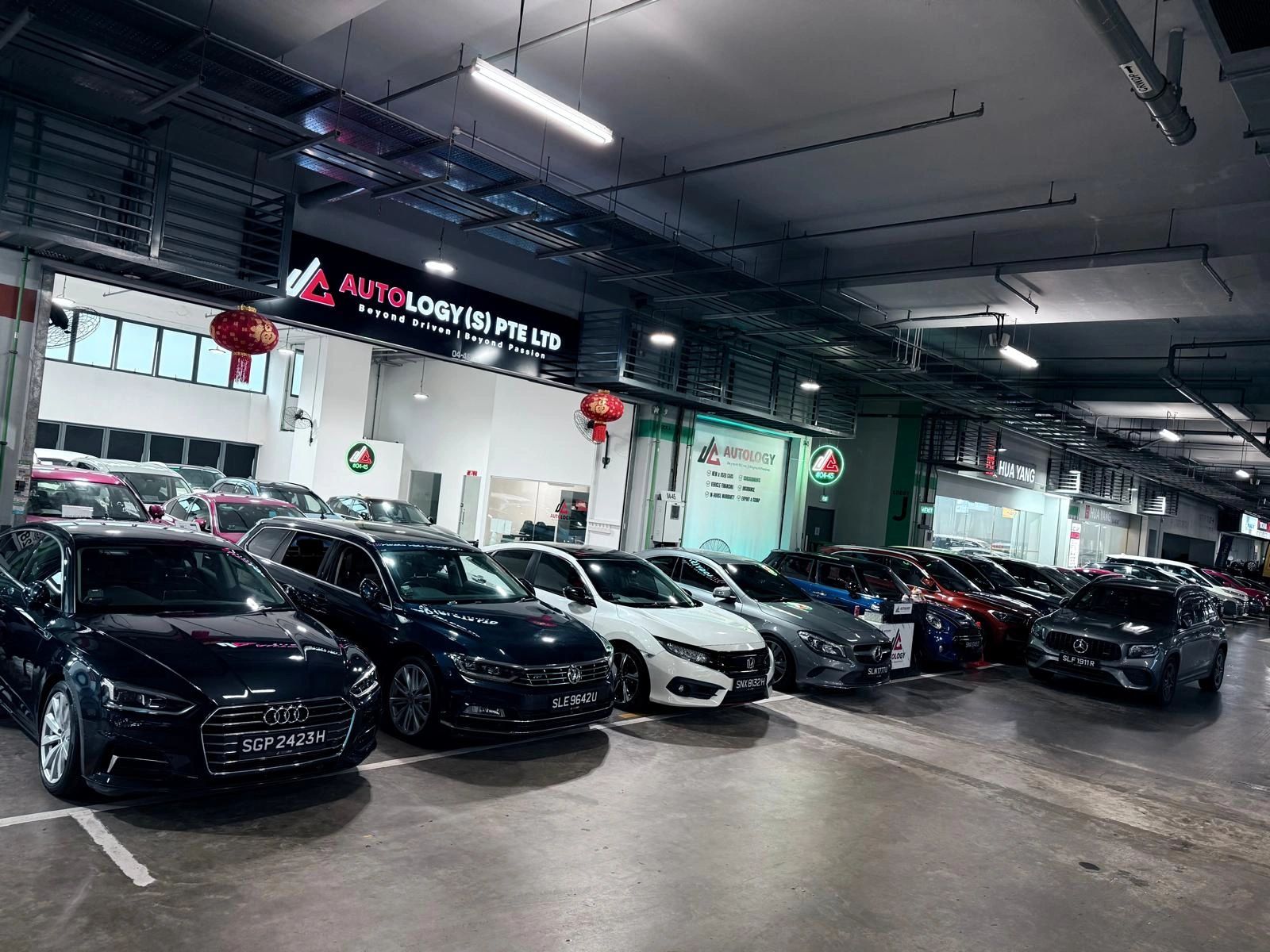 A lineup of luxury cars parked inside Autology's garage.