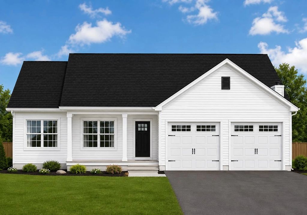 A modern white house with black roof and double garage doors.