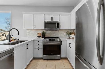 Kitchen mini renovation with new countertop, fixtures, cupboards painted with new hardware, potlight