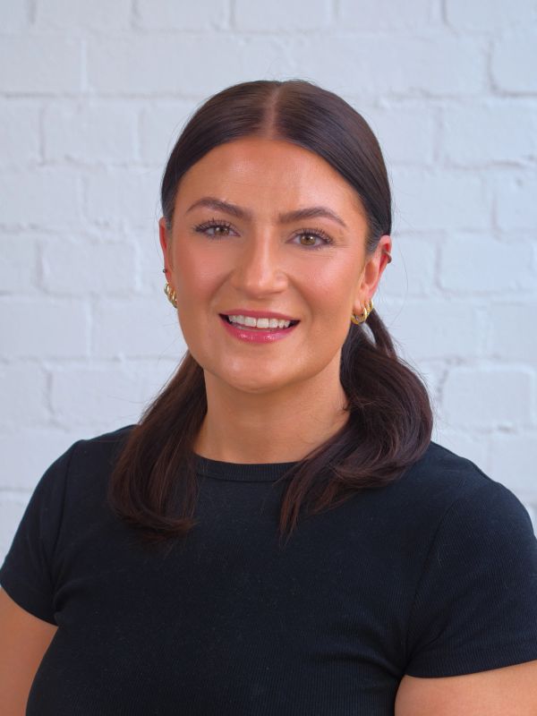 Woman smiling for a Business headshot photographer capturing a team in west London, Ealing