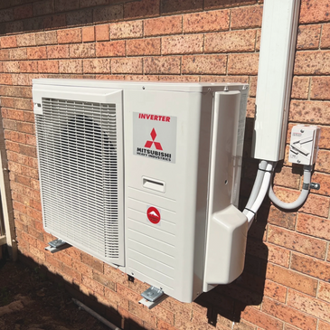 Mitsubishi split system external unit mounted to brick wall