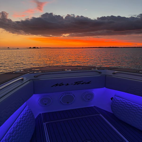 Colorful sunset over water from a boat's deck.