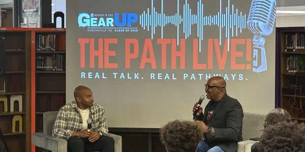 Brandon Foster engaged in a live discussion event titled 'THE PATH LIVE!' in front of an audience.