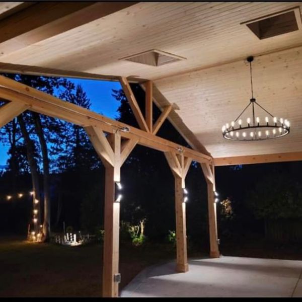Large gable patio cover with lighting and concrete patio. Custom patio cover with skylights.