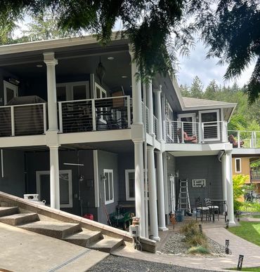 second story wrap around composite deck with cable and metal railing