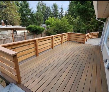 brown deck with wood railing. New built deck by general contractor.