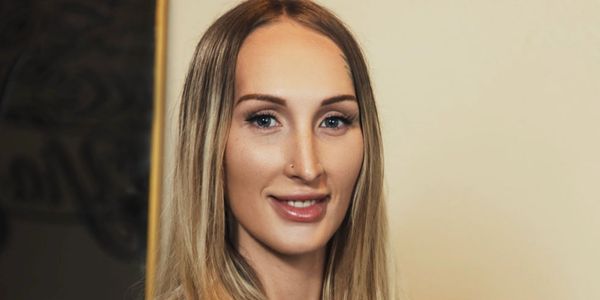 Portrait of a smiling woman with long blonde hair.
