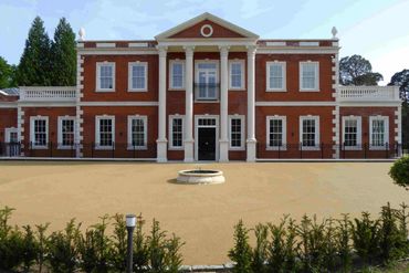 View of new large house with two storeys and basement in Wentworth, Surrey. 