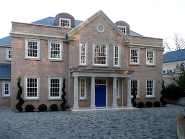 Front view of completed new two storey house with rooms in loft above in Walton, Surrey.