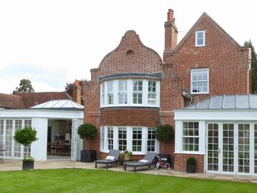 View of Georgian house with new kitchen living area house extension and new orangery.