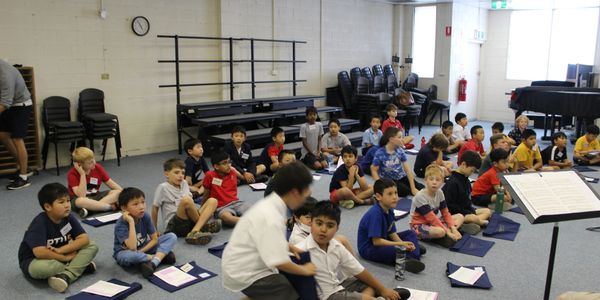 Group of boys at choir rehearsal sitting on floor at National Boys Choir studios
