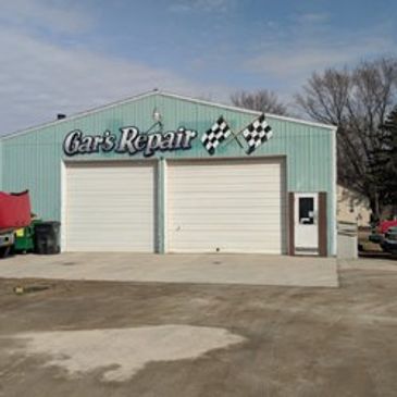 Exterior of Gar's Repair garage with two closed doors.