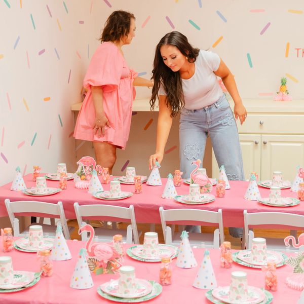 pink flamingo co-owners prepare the party room for a children's birthday party in the party space.