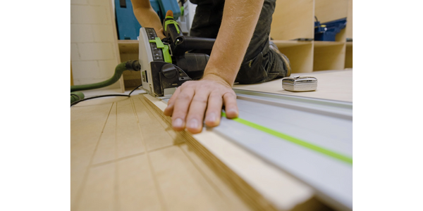 A picture of measuring wood with the machine