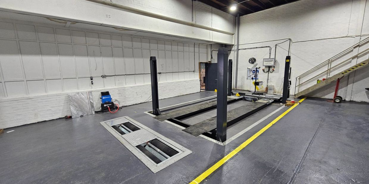 Empty car service bay inside a garage.