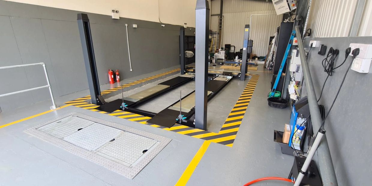 Car service lift in a clean garage.