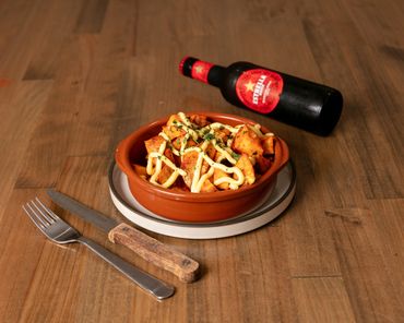Bravas - Double fried potatoes with fiery tomato sauce, sweet paprika, and aioli. Ft Estrella beer.