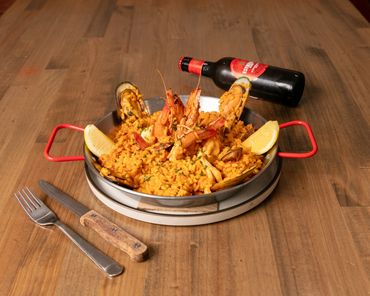 Seafood Paella - king prawns,  mussels, and calamari. Cooked with shellfish bisque and bomba rice.