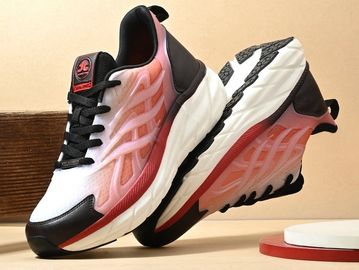 Stylish white and pink sports shoes with black accents.