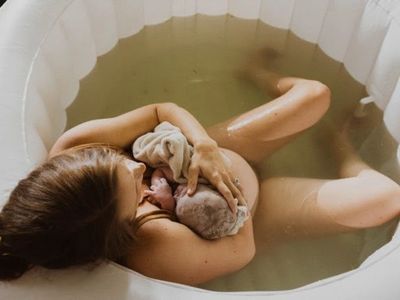 Water birth immediate postpartum birth pause snuggling newborn