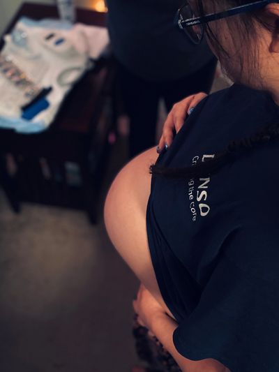 Pregnant woman belly birth supplies in background homebirth waiting patience