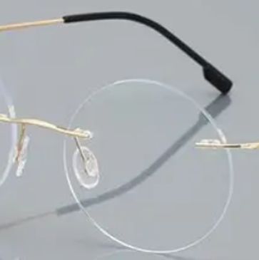 Elegant rimless glasses with gold and black temples.